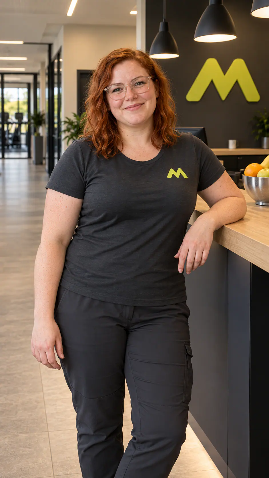 Fenja Musterfrau mit Brille, an die Theke gelehnt.